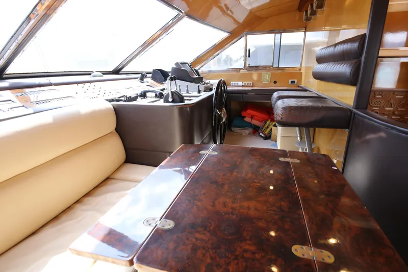  Yacht Photos Pics Luxurious interior of 1990 Sanlorenzo 80 yacht with elegant wood and leather finishes.