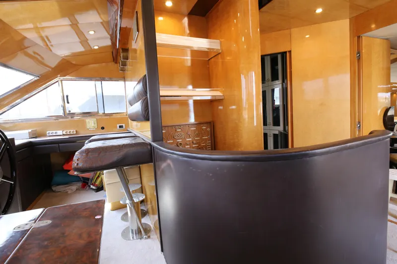  Yacht Photos Pics Interior of 1990 Sanlorenzo 80 yacht with modern wood finishes and seating area.