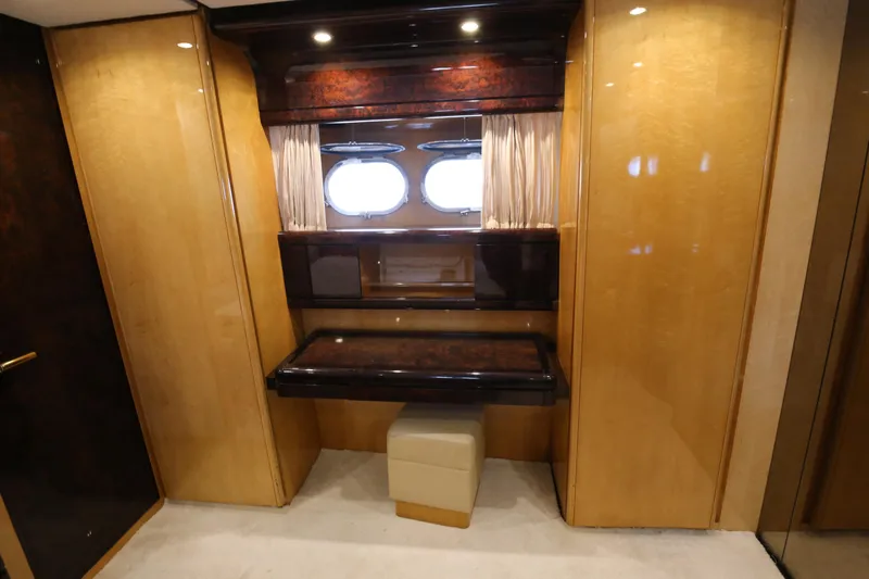  Yacht Photos Pics Luxurious interior of 1990 Sanlorenzo 80 yacht with elegant wood paneling and porthole windows.