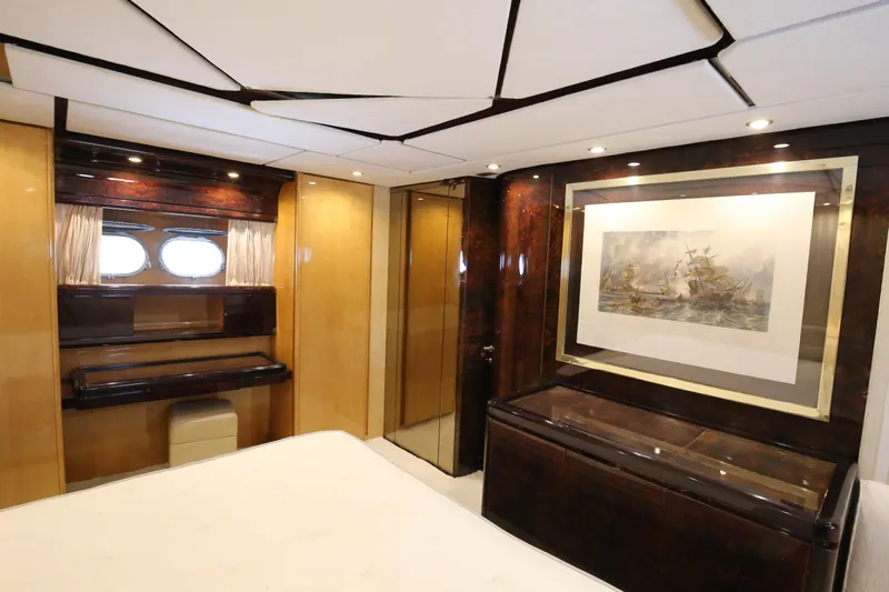  Yacht Photos Pics Luxurious interior of 1990 Sanlorenzo 80 yacht with elegant wood finishes and artwork.