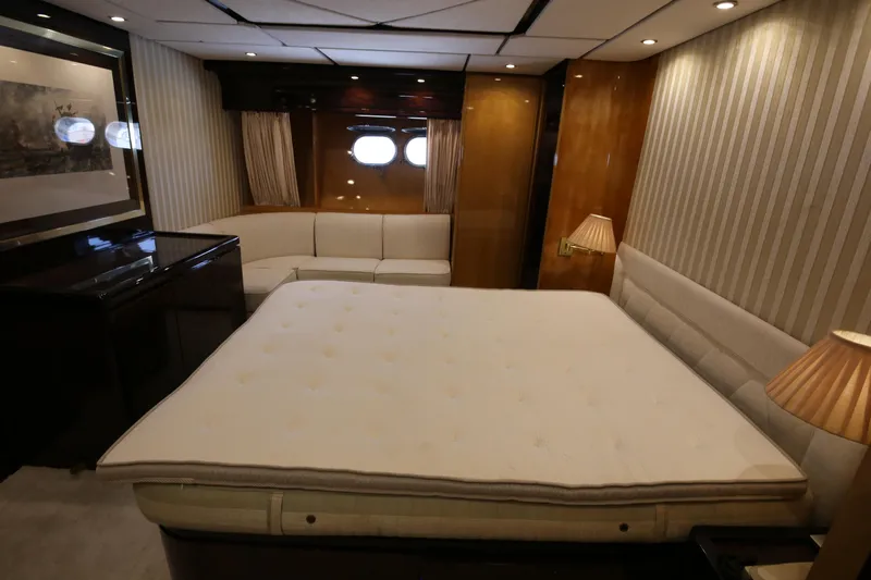  Yacht Photos Pics Luxurious bedroom interior of 1990 Sanlorenzo 80 yacht with elegant furnishings and ambient lighting.