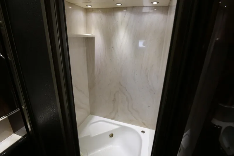 Yacht Photos Pics Luxurious marble shower in 1990 Sanlorenzo 80 yacht, featuring elegant recessed lighting.