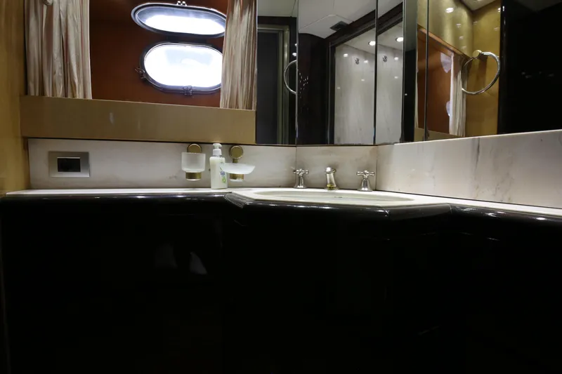  Yacht Photos Pics Luxurious bathroom interior of 1990 Sanlorenzo 80 yacht with elegant fixtures and mirrors.