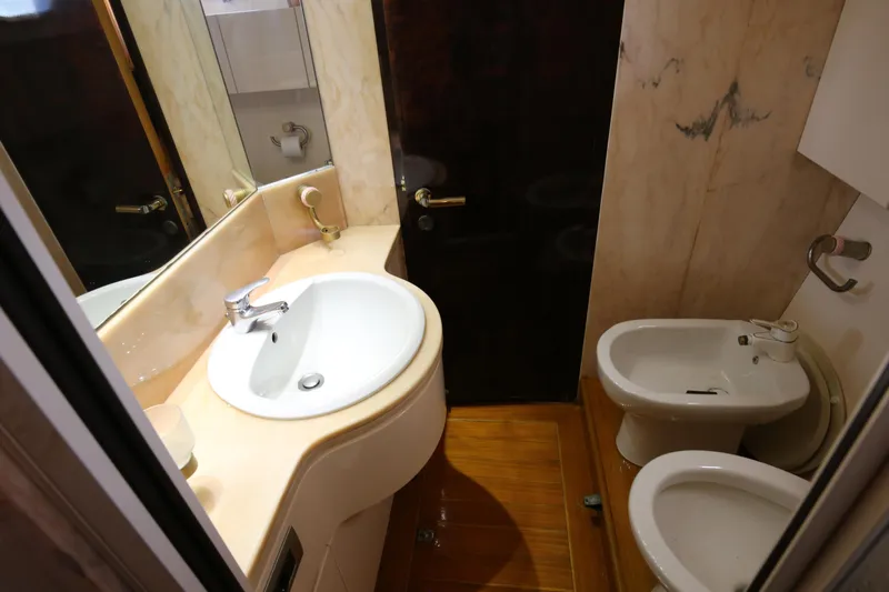  Yacht Photos Pics Bathroom interior of 1990 Sanlorenzo 80 yacht with sink, toilet, and bidet.