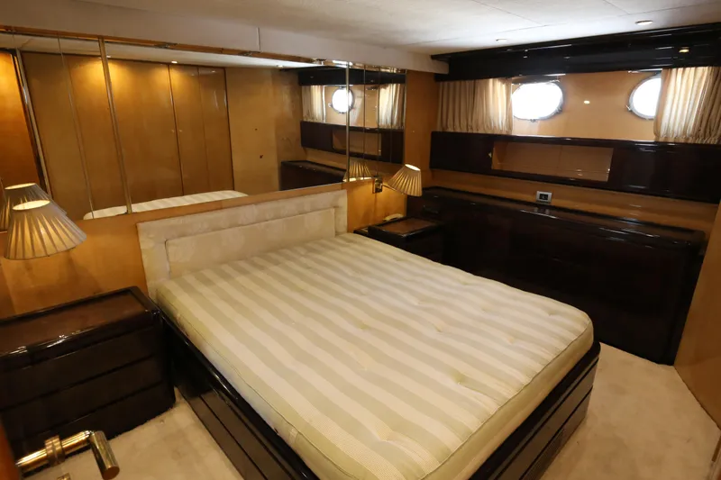  Yacht Photos Pics Luxurious bedroom interior of 1990 Sanlorenzo 80 yacht with elegant furnishings.