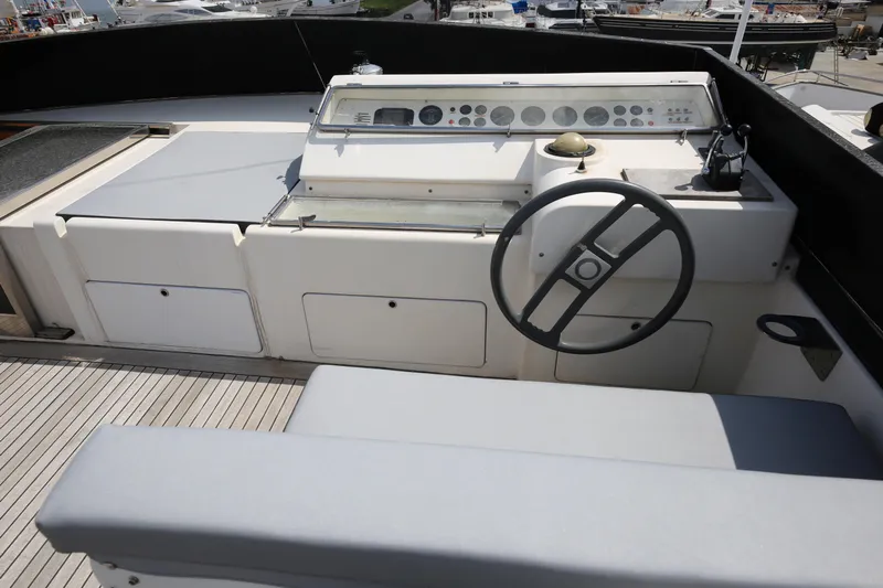  Yacht Photos Pics Cockpit of 1990 Sanlorenzo 80 yacht with steering wheel and control panel.