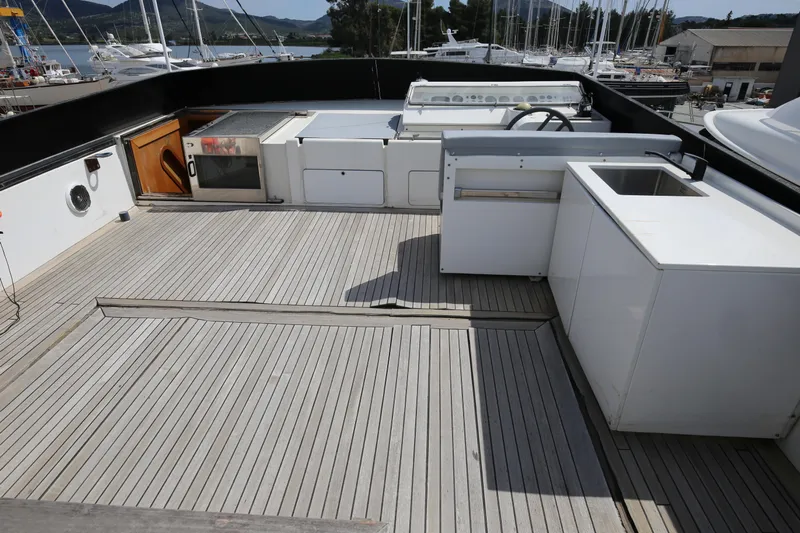  Yacht Photos Pics Spacious deck of 1990 Sanlorenzo 80 yacht with outdoor kitchen amenities.