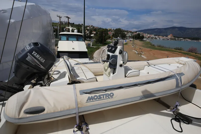  Yacht Photos Pics Sanlorenzo 80 yacht with Yamaha engine and inflatable boat, docked near scenic coastline, 1990 model.