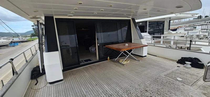  Yacht Photos Pics Sanlorenzo 80 yacht deck, 1990 model, featuring spacious outdoor area with table.