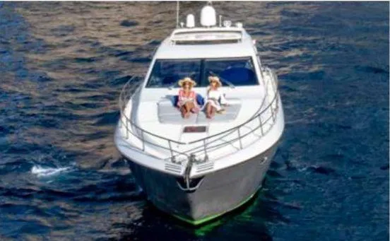  Yacht Photos Pics 2005 Uniesse 54 Sport yacht cruising with two people relaxing on deck.