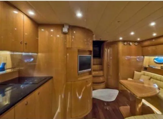  Yacht Photos Pics Luxurious interior of 2005 Uniesse 54 Sport yacht with wood finish and modern amenities.