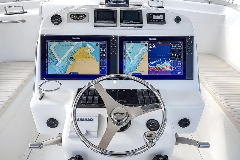 Never Enough Yacht Photos Pics Helm of 2017 Out Island SeaTek 36 Express with dual Simrad displays and steering wheel.
