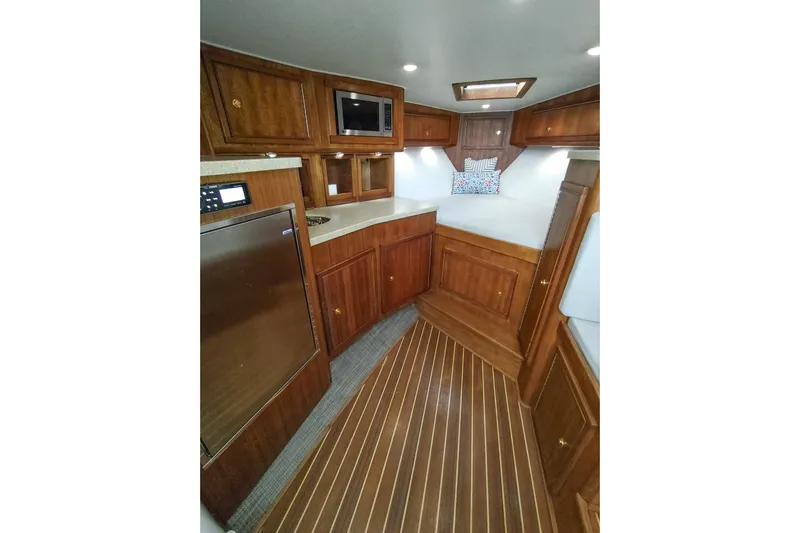 Never Enough Yacht Photos Pics 2017 Out Island SeaTek 36 Express cabin interior with wood finish and modern amenities.