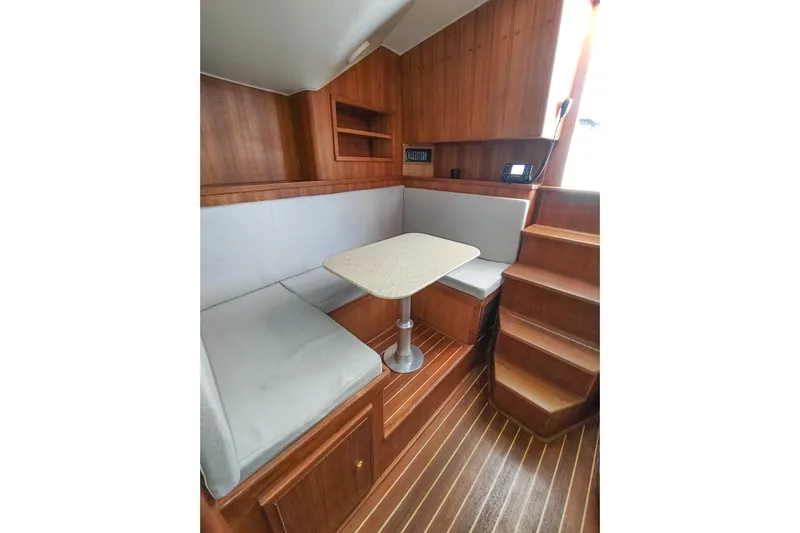Never Enough Yacht Photos Pics 2017 Out Island SeaTek 36 Express cabin with wooden interior and cozy seating area.