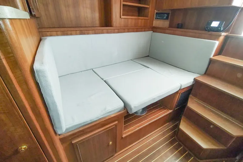 Never Enough Yacht Photos Pics 2017 Out Island SeaTek 36 Express cabin with wooden interior and cushioned seating.