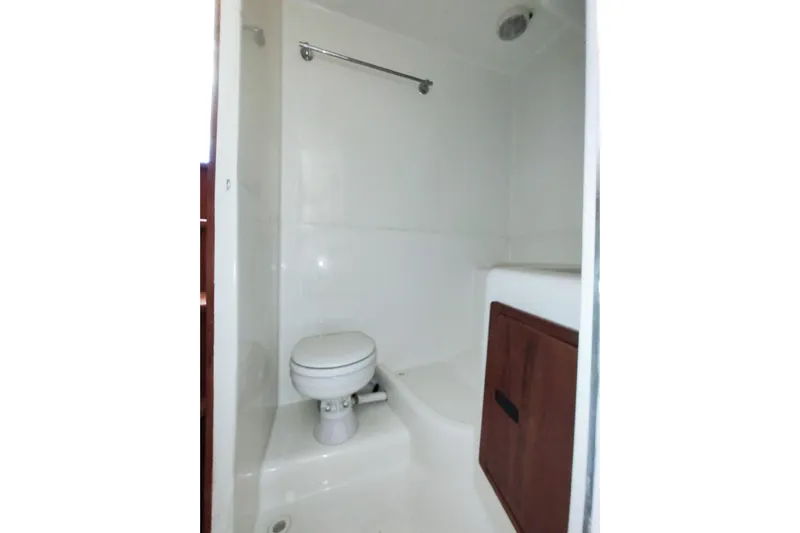 Never Enough Yacht Photos Pics Bathroom interior of 2017 Out Island SeaTek 36 Express boat, featuring a compact toilet.