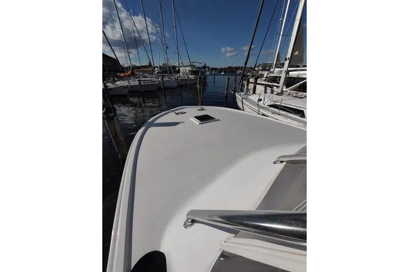 Never Enough Yacht Photos Pics 2017 Out Island SeaTek 36 Express boat docked at a marina under clear skies.