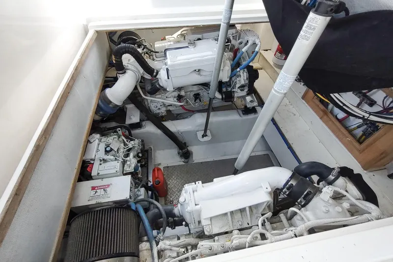 Never Enough Yacht Photos Pics Engine compartment of 2017 Out Island SeaTek 36 Express boat, showcasing dual engines.