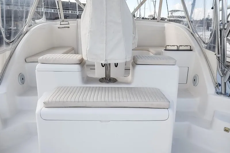 Never Enough Yacht Photos Pics 2017 Out Island SeaTek 36 Express boat interior with white cushioned seating.