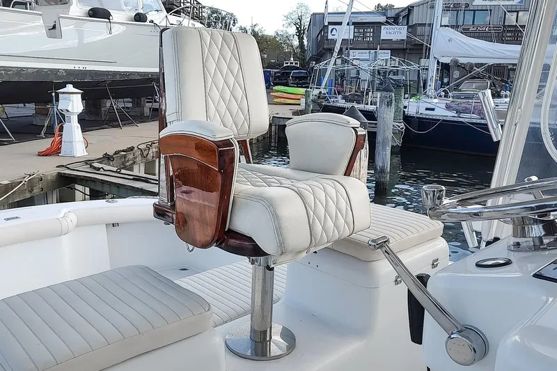 Never Enough Yacht Photos Pics Captain's chair on 2017 Out Island SeaTek 36 Express boat, docked at marina.