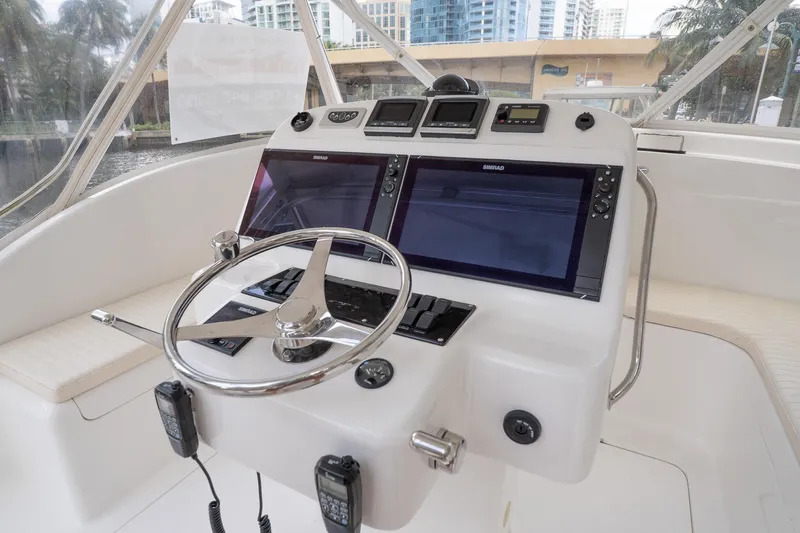 Never Enough Yacht Photos Pics Helm of 2017 Out Island SeaTek 36 Express with dual Simrad displays and modern controls.