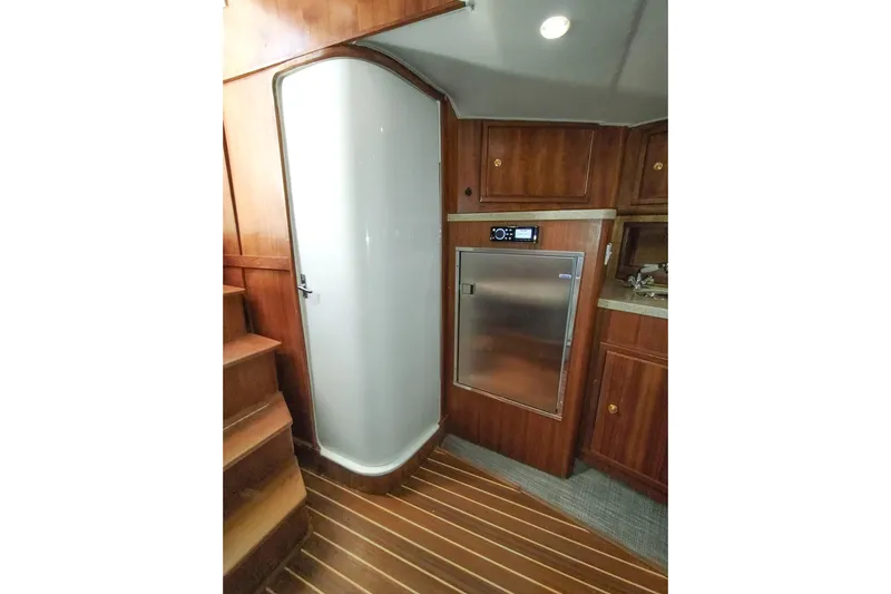 Never Enough Yacht Photos Pics 2017 Out Island SeaTek 36 Express interior with wooden cabinetry and compact shower.