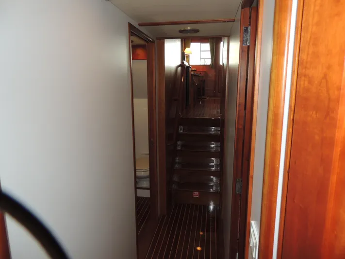 Nighthawk Yacht Photos Pics Interior of 1999 Lyman-Morse pilothouse yacht with wooden finishes and staircase.