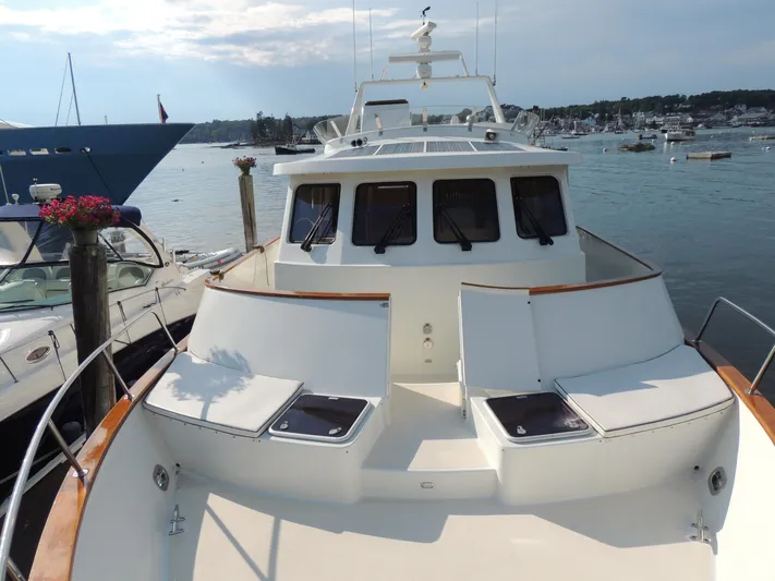 Nighthawk Yacht Photos Pics 1999 Lyman-Morse pilothouse yacht docked in a scenic marina setting.