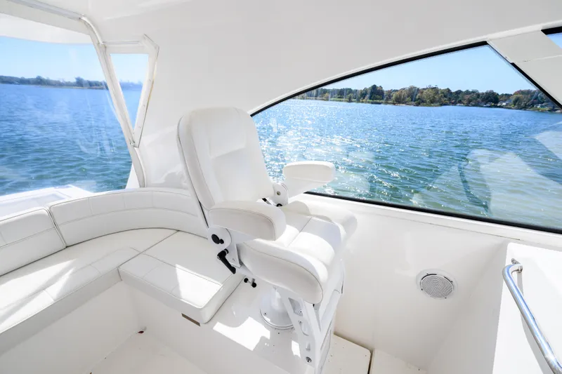 Ghost Yacht Photos Pics 2013 Cabo 40 Hardtop Express interior with white seating, overlooking serene water view.
