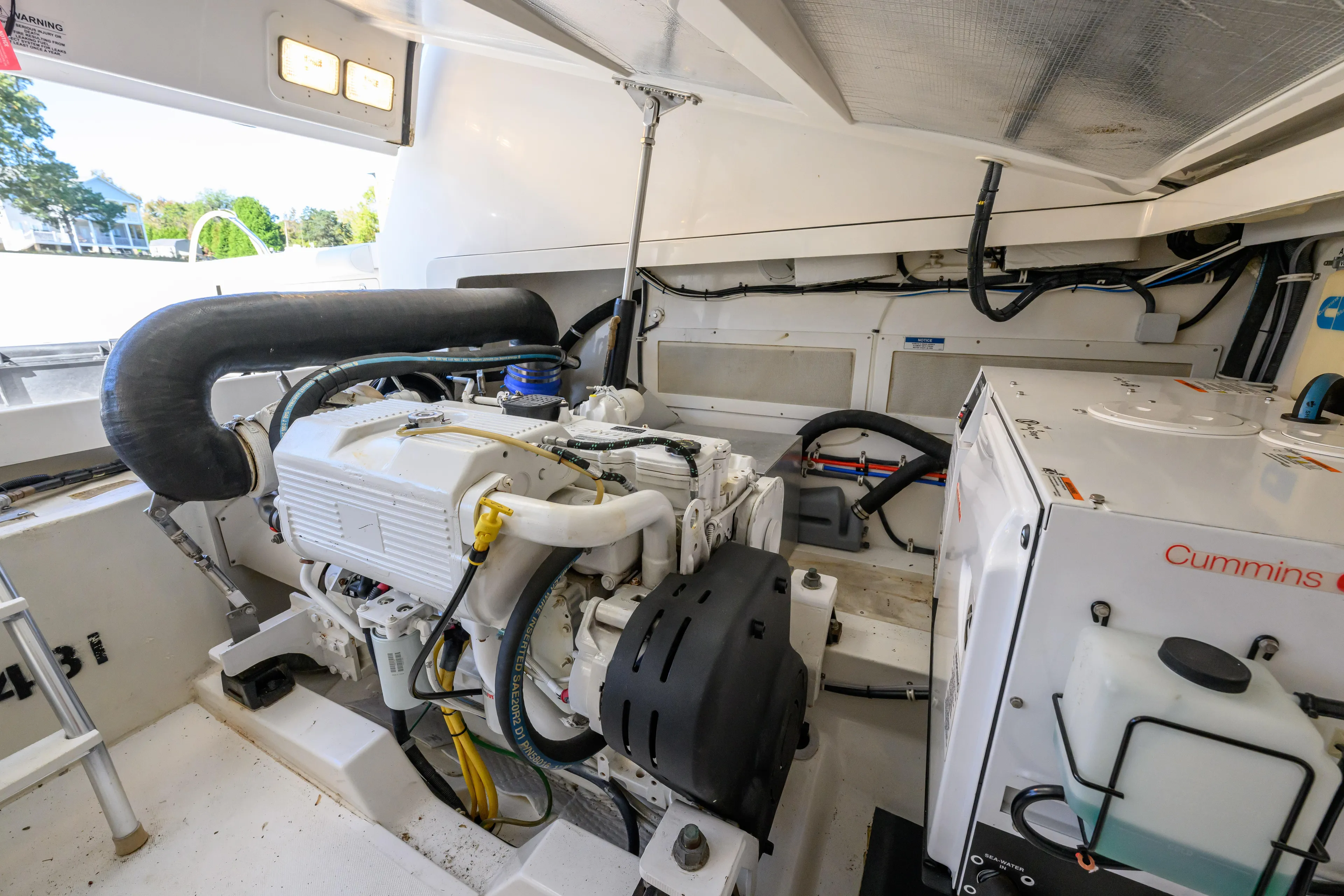 Ghost Yacht Photos Pics Engine room of 2013 Cabo 40 Hardtop Express with Cummins generator and mechanical components.