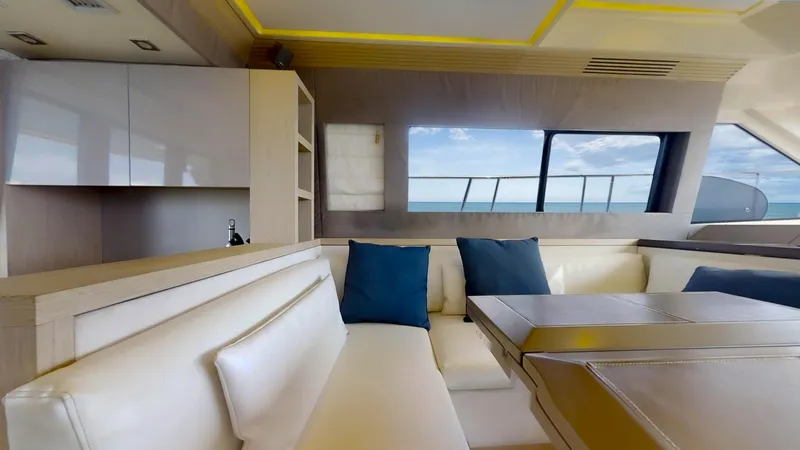  Yacht Photos Pics Luxurious interior of 2016 Monte Carlo Yachts MC5 with elegant seating and ocean view.