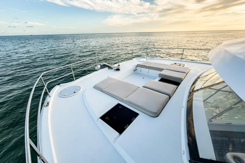 Hawkeye Yacht Photos Pics 2022 Fountaine Pajot MY6 yacht deck with sun loungers, ocean view at sunset.