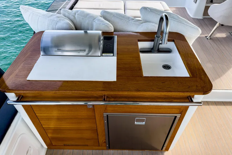 Hawkeye Yacht Photos Pics Outdoor kitchen on 2022 Fountaine Pajot MY6 yacht with sink and grill.