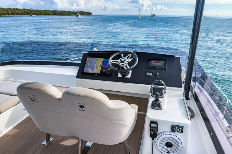 Hawkeye Yacht Photos Pics 2022 Fountaine Pajot MY6 yacht helm with ocean view, featuring modern navigation equipment.