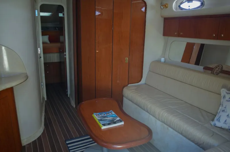  Yacht Photos Pics Interior of 2001 Sea Ray Express Cruiser with beige seating and wooden cabinetry.
