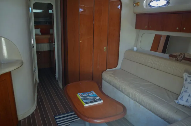  Yacht Photos Pics Interior of 2001 Sea Ray Express Cruiser with cozy seating and wooden cabinetry.