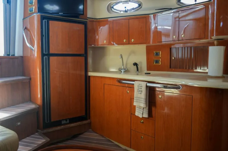  Yacht Photos Pics 2001 Sea Ray Express Cruiser kitchen with wood cabinets and modern appliances.