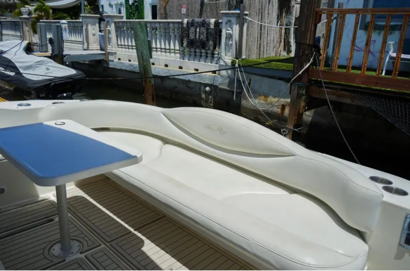  Yacht Photos Pics 2001 Sea Ray Express Cruiser with white seating and blue table, docked by waterfront.