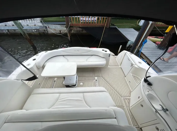  Yacht Photos Pics 2001 Sea Ray Express Cruiser with spacious seating and table, docked by the water.