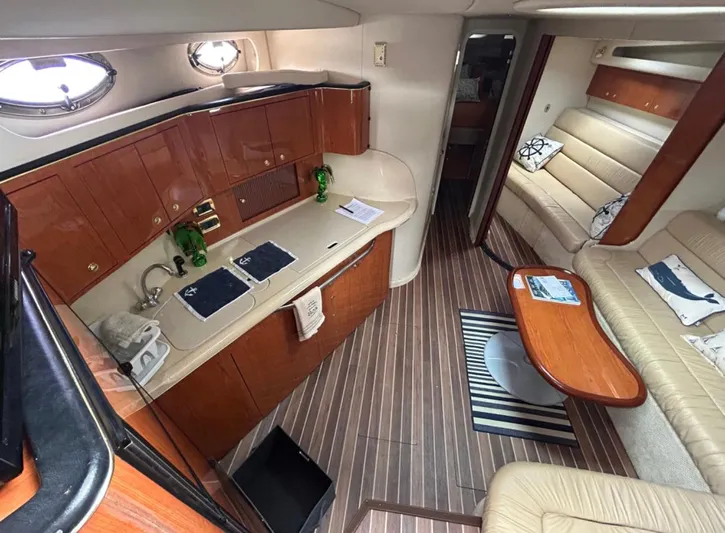  Yacht Photos Pics Interior of a 2001 Sea Ray Express Cruiser with wood cabinetry and seating area.