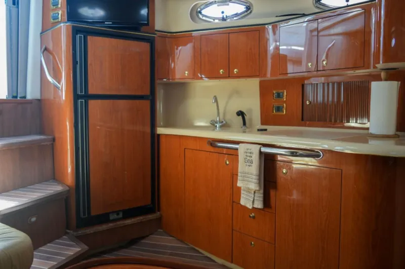  Yacht Photos Pics 2001 Sea Ray Express Cruiser interior with wooden cabinets, compact kitchen, and modern amenities.