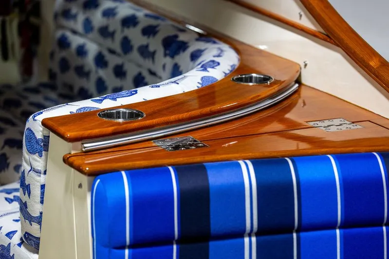 Valor Yacht Photos Pics Interior of 2014 Hinckley Talaria 34 with elegant wood finish and patterned upholstery.