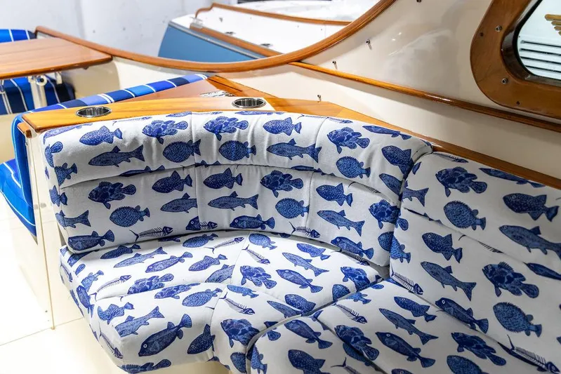 Valor Yacht Photos Pics Interior of 2014 Hinckley Talaria 34 with fish-patterned seating and wooden accents.