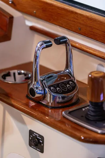 Valor Yacht Photos Pics Hinckley Talaria 34 2014 boat controls with polished chrome and wood accents.
