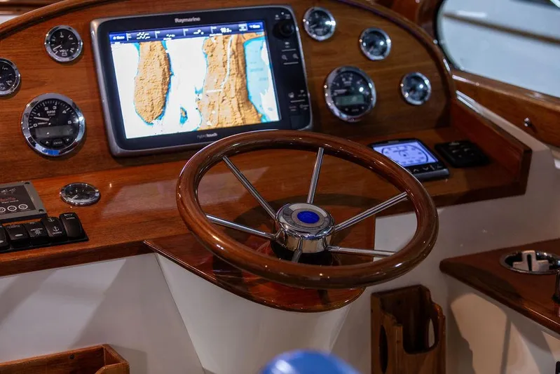Valor Yacht Photos Pics 2014 Hinckley Talaria 34 helm with wooden steering wheel and navigation display.