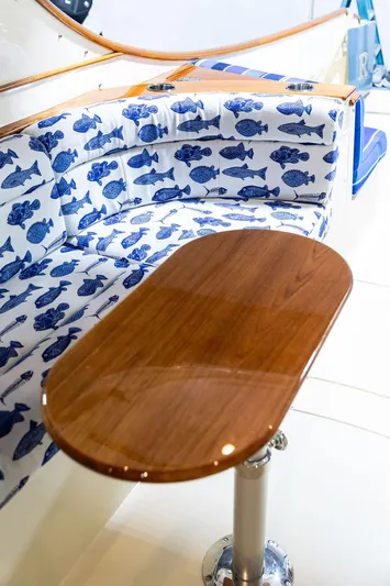 Valor Yacht Photos Pics Hinckley Talaria 34 (2014) boat interior with fish-patterned seating and wooden table.