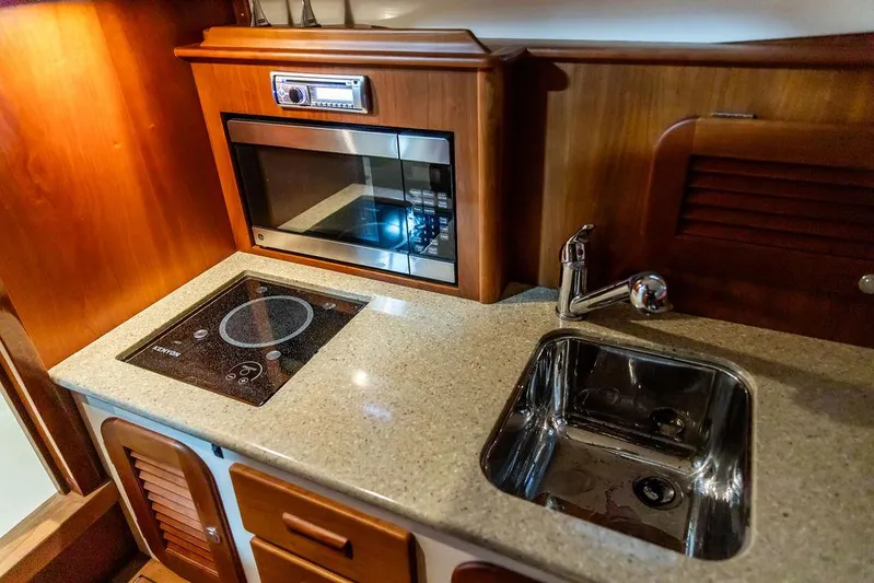 Valor Yacht Photos Pics 2014 Hinckley Talaria 34 yacht kitchen with stove, sink, and microwave.