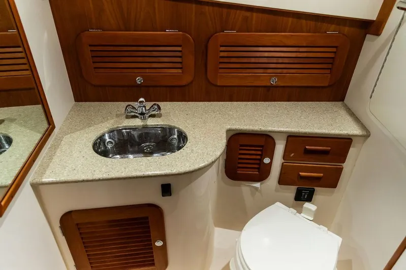 Valor Yacht Photos Pics Luxurious 2014 Hinckley Talaria 34 yacht bathroom with wood accents and modern fixtures.
