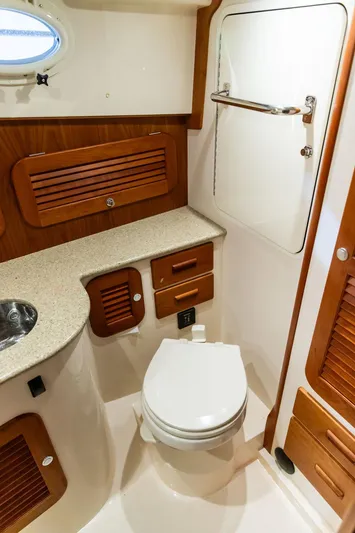 Valor Yacht Photos Pics 2014 Hinckley Talaria 34 yacht bathroom with wooden accents and modern fixtures.