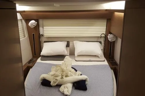 Lone Star Lagoon Yacht Photos Pics Luxurious cabin interior of 2019 Lagoon 50 yacht with neatly arranged bed.